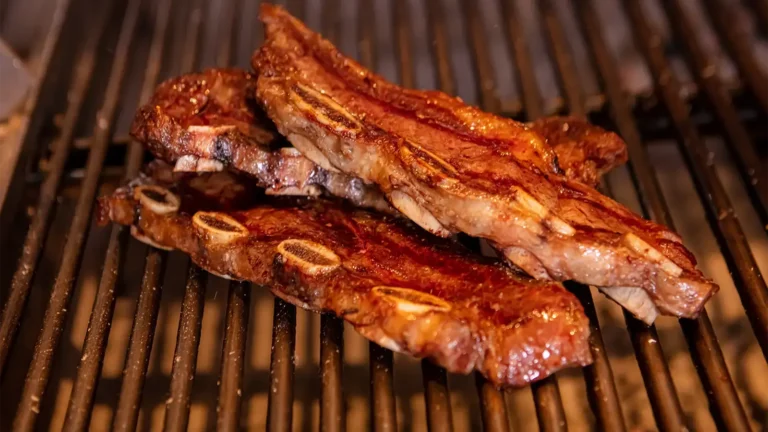 Two cooked Argentine steaks on a grill