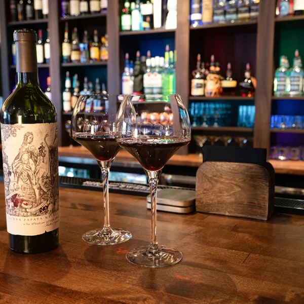 two glasses of wine sit on the bar at Libertango